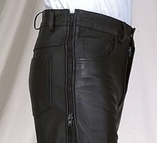 A man wearing black leather pants with zippers.