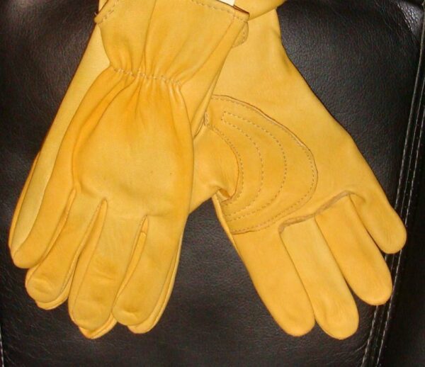 A pair of Deerskin leather western riding Roper gloves USA made on a black chair.