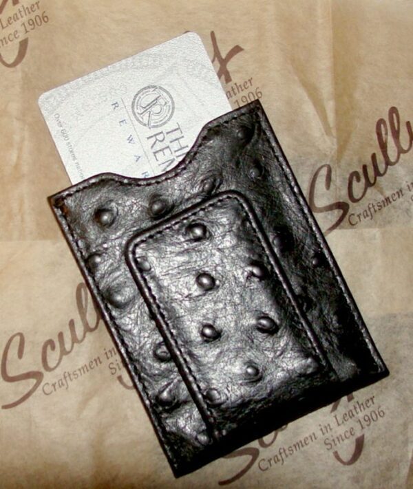 A Scully Black Ostrich leather magnetic money clip with an ostrich skin on it.