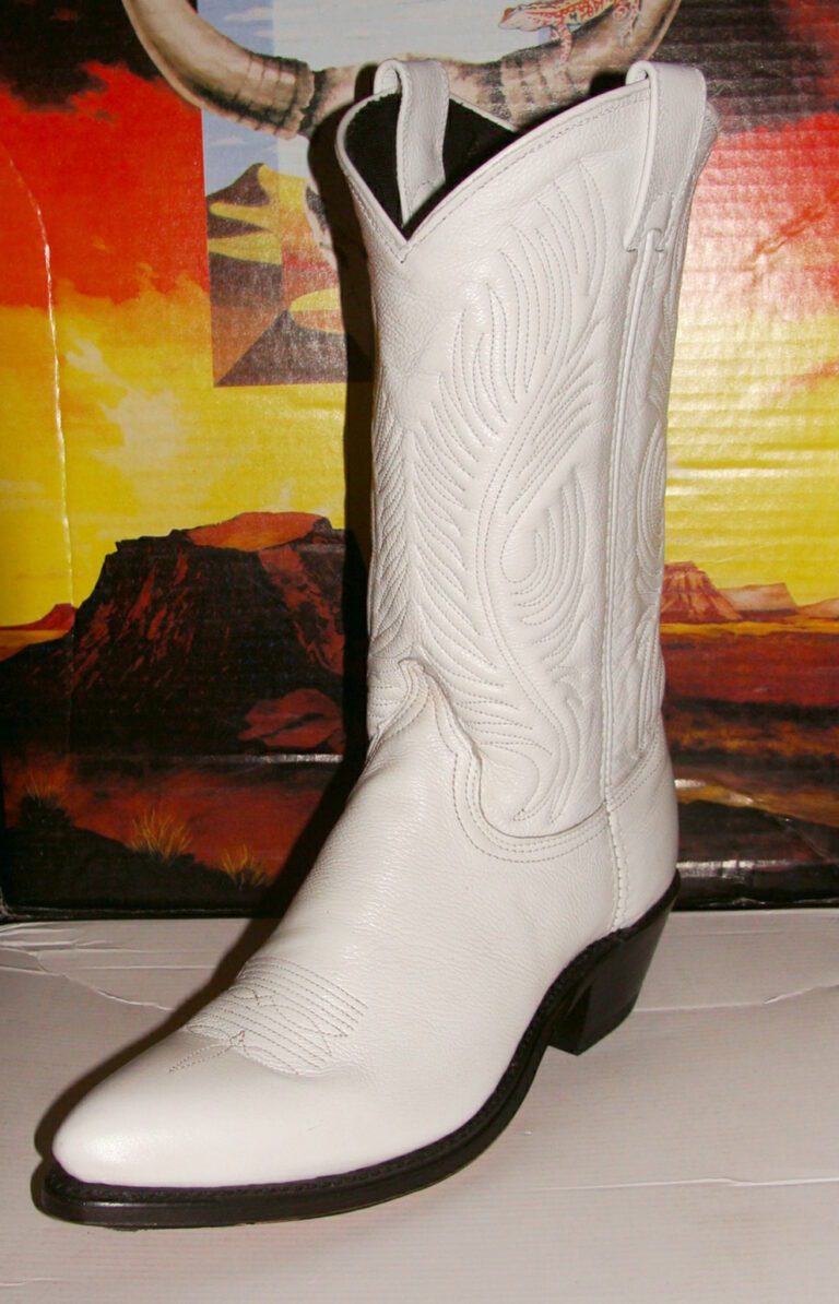 A pair of Women's White Leather Cowboy Boots- USA made on top of a box.