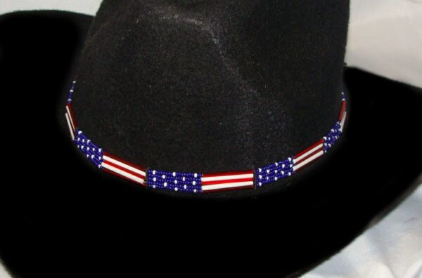 A black cowboy hat with a Glass quill 5 strand "USA Flag" USA MADE hat band on it.