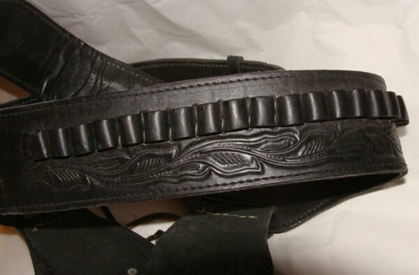 A .45 Caliber Black Tooled Leather Single Western Gun Holster with a pattern on it.