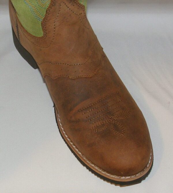 A pair of brown size 8.5 "Green Showdown" Distressed womens cowboy boots with green soles.