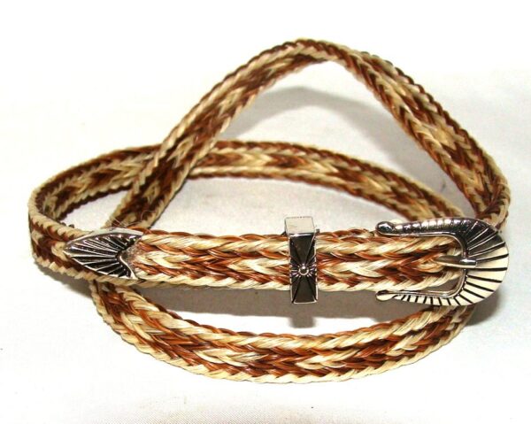A brown and white braided belt with a Sterling Silver Buckle.