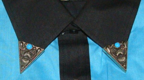 A close up of a blue and black shirt with German silver Turquoise stone collar tips.