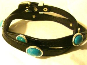 A Sterling Silver Buckle Turquoise stone black leather hat band with turquoise stones.