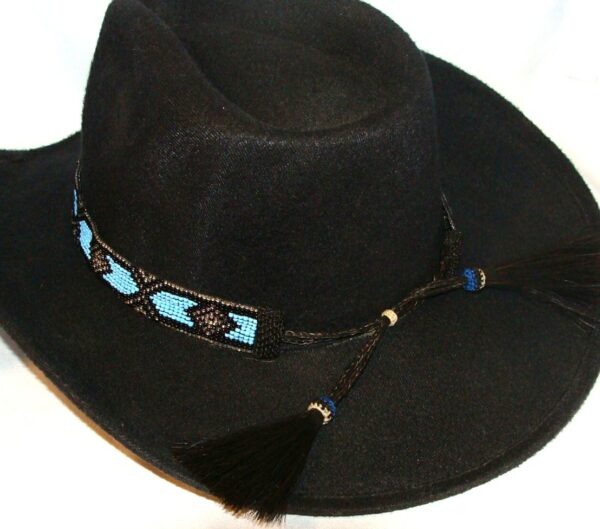 A black cowboy hat with a Blue beaded Horse hair tassel Navajo hat band.