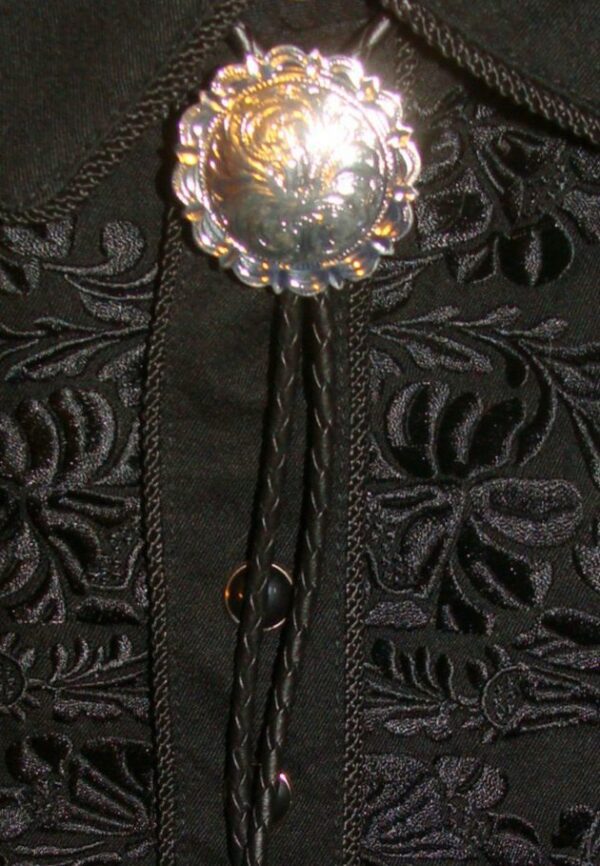 A close up of a black jacket with a "Rex" Large Silver western bolo tie.