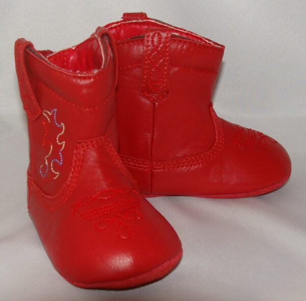 A pair of "Fire Engine Red" infant, red baby cowboy boots on a white surface.
