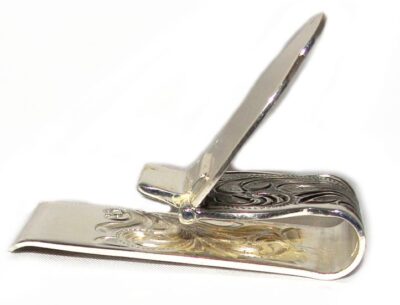 A Silver Engraved Fold Over Western Money Clip with an ornate design.