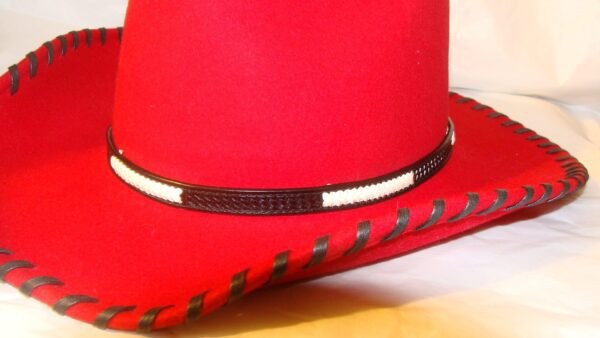 A red leather cowboy hat with a Black Woven Basket weave leather Rawhide hat band.