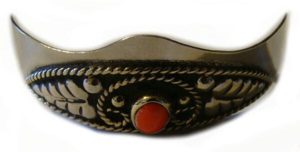 A silver ring with Red Coral stone Silver Cowboy boot heel guards.