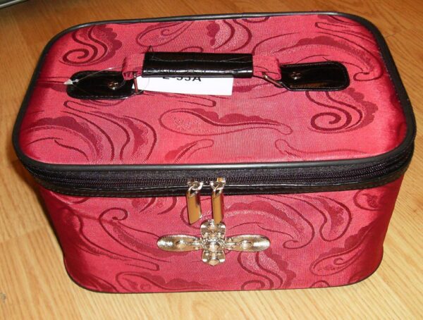 A 19" Red & Black croc print leather rolling carry on luggage set sitting on a wooden floor.