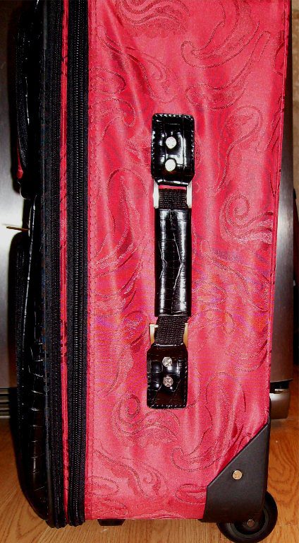 A 19" Red & Black croc print leather rolling carry on luggage set on wheels.