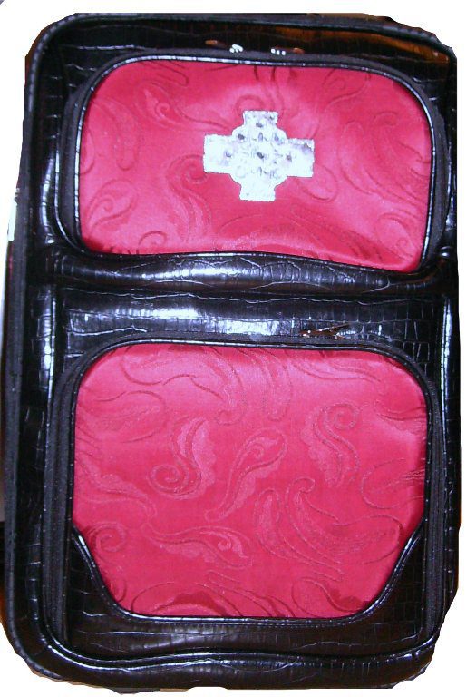A 19" Red & Black croc print leather rolling carry on luggage set with a cross on it.