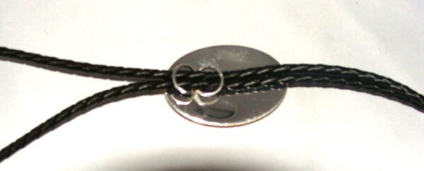 A black cord with a silver ring attached to it.
