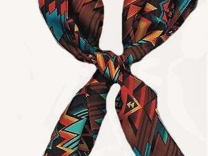 A USA MADE Aztec Orange Turquoise Silk Western Scarf with an aztec pattern on it.