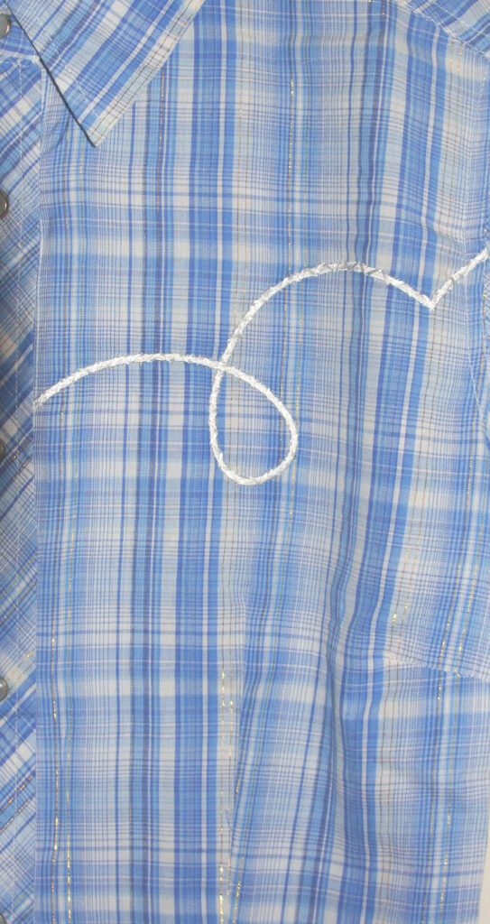 A blue and white plaid shirt with a white arrow on it.