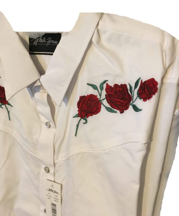 A Womens Red Texas Rose White Western Shirt with red roses embroidered on it.