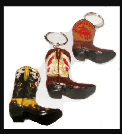 Three Ceramic Single Cowboy Boot Keychains on a white background.