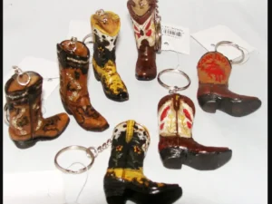 A group of Ceramic Single Cowboy Boot Keychains, Western Keyrings on a white background.
