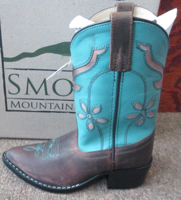 A blue and "Turquoise Cactus Flower" Youth 7 Womens 9 cowgirl boot in front of a box.