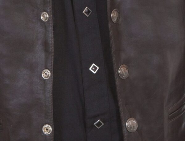 A close up of a man wearing a Mens Scully Brown Lambskin Buffalo Snap Front Western Vest.