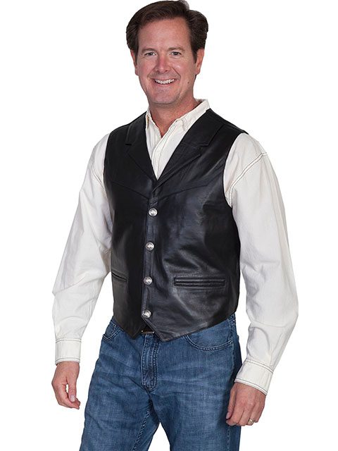 A man wearing a Mens Scully Black Lambskin Buffalo Snap Front Western Vest and jeans.