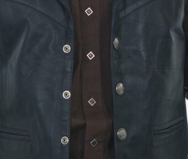 A man wearing a Mens Scully Black Lambskin Buffalo Snap Front Western Vest with brown buttons.