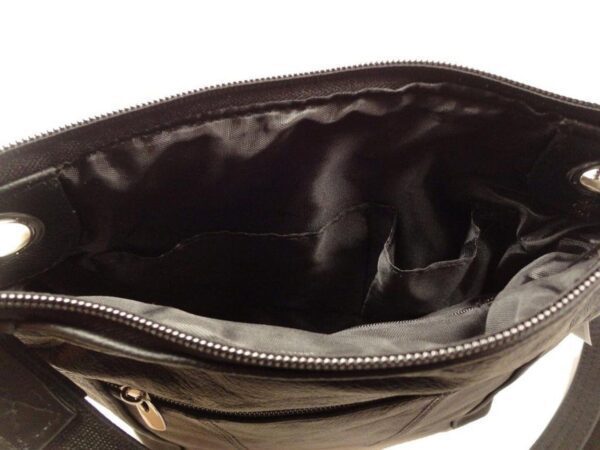 The inside of a "Elaine" Women's Brown Leather Stud Concealed Handbag with zippers.
