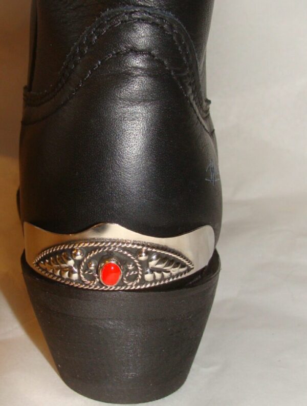 A black cowboy boot with Red Coral stone Silver Cowboy boot heel guards on the heel.