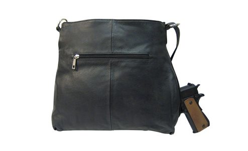 A "Brittany" Women's Black & Brown Leather Concealed Handbag with a gun in it.