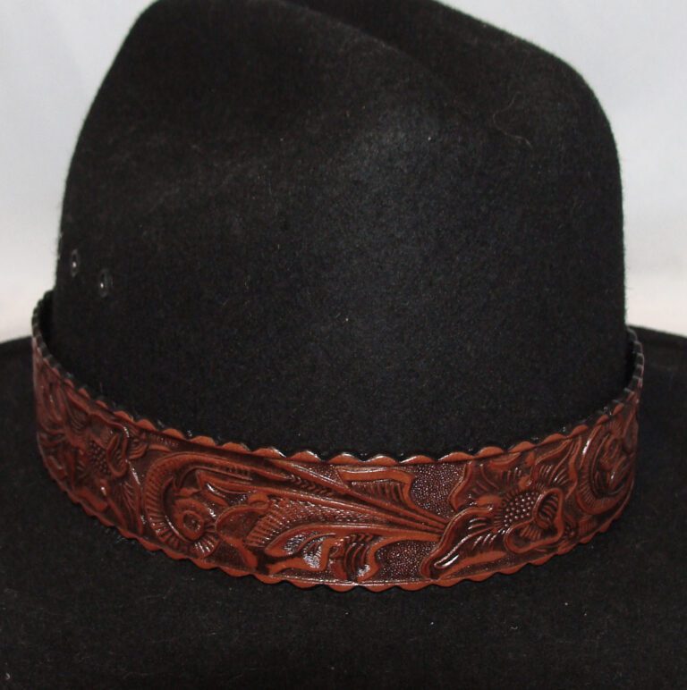 A black hat with a brown leather engraved band
