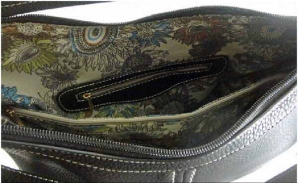 The inside of a "Lisa" Women's Vegan Leather Tan Concealed Handbag with a floral pattern.