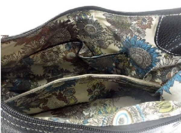 A close up of the "Lisa" Women's Black Vegan Leather Concealed Handbag with a floral pattern.