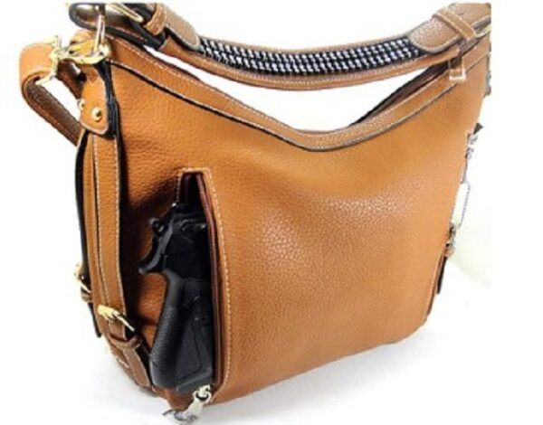 A "Lisa" Women's Vegan Leather Tan Concealed Handbag with a gun in it.