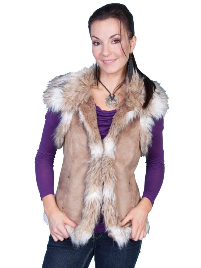 A woman wearing a Women's Scully Faux Suede, Hazelnut Fur Western Vest with a fur collar.