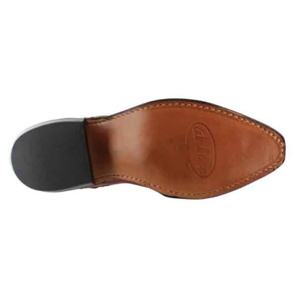 A close up of a brown shoe with a black sole.