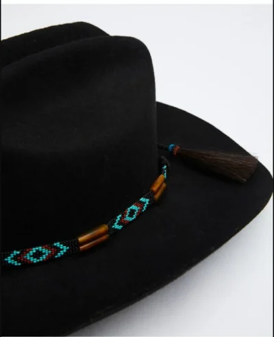 Brown Cow Bones Turquoise Beaded Hand Beaded Cowboy Hat Band <ul> <li>Real Bones</li> <li>Horse Hair tie</li> <li>1/2" wide band</li> <li>Will fit up to 28"</li> <li>MADE IN THE U.S.A</li> </ul> •