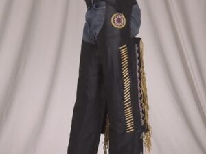 A man wearing a pair of Native beaded black leather fringe chaps.