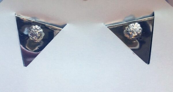 A pair of Silver and Gold Gun collar tips adorned with sparkling diamonds.