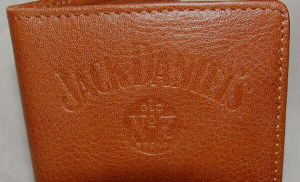 A brown leather wallet with the Whiskey "Signature Rodeo" Jack Daniels checkbook wallet logo on it.
