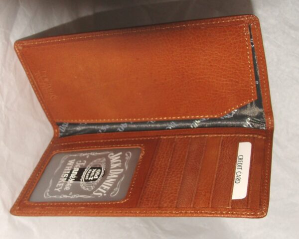 A Whiskey "Signature Rodeo" Jack Daniels checkbook wallet with a card in it.