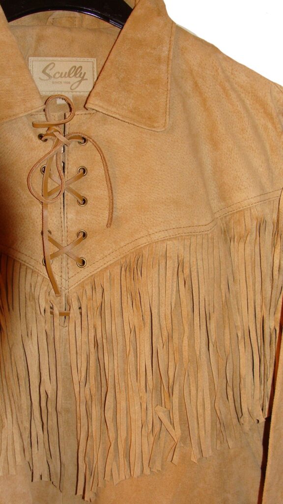 A tan suede jacket with fringes.