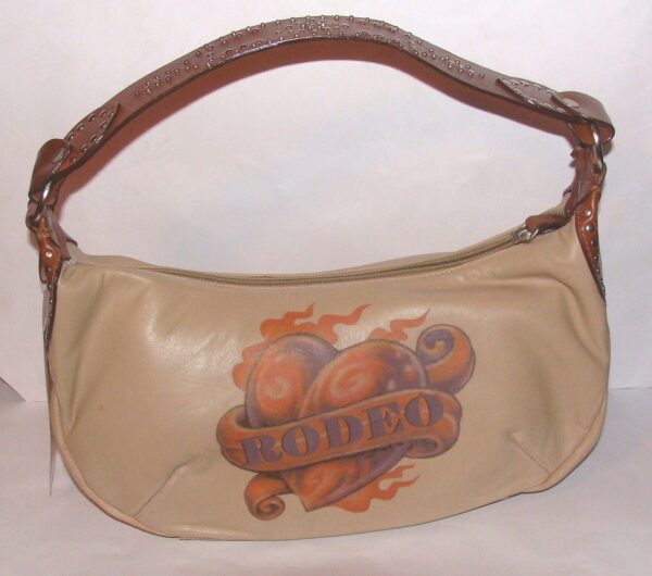 A "Cowboy Love" Scully leather tattoo western hand bag with an image of a rodeo on it.