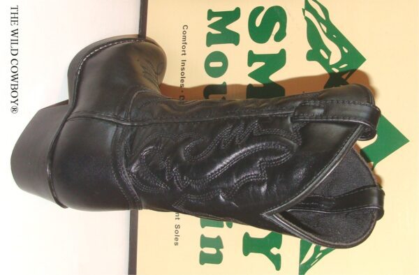A pair of Child 11 WIDE "Denver" Black leather cowboy boots sitting on top of a box.