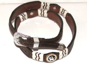 A brown and white leather bracelet with a silver buckle.