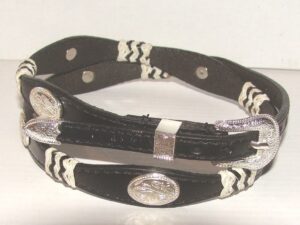 A black and white leather bracelet with a silver buckle.