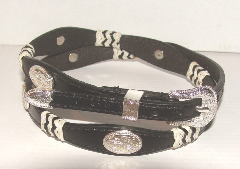 A black and white leather bracelet with a silver buckle.