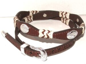 A brown and white leather belt with a silver buckle.